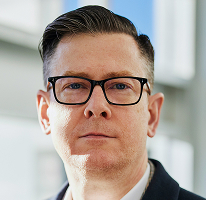 Ritratto di Alexander Hughes executive e CEO di un'azienda di trading di criptovalute